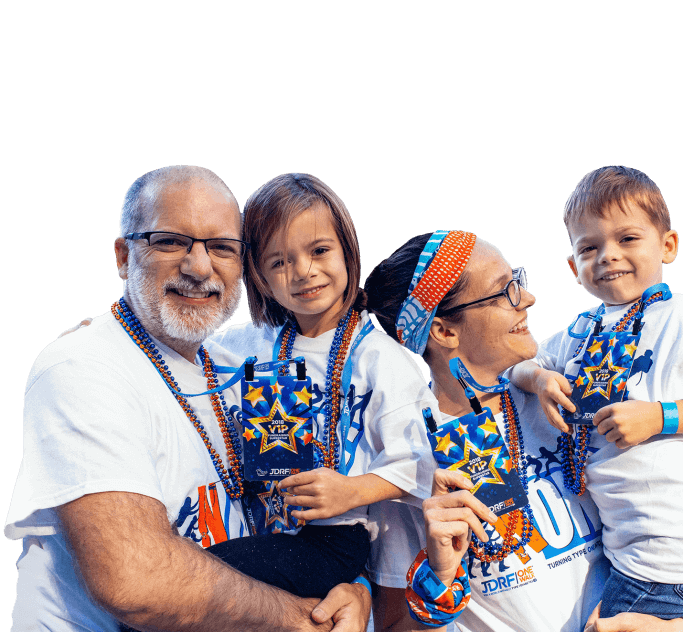 A mother, father, boy, and girl smile and hold up their T1D One Walk badges while wearing JDRF T-shirts and orange and blue beads