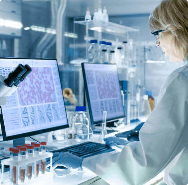 type 1 diabetes female researcher in a lab setting, standing in front of computer analyzing cell cultures and DNA structures