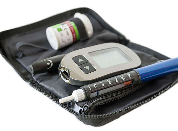 A small, black zip-up pouch containing a syringe, a modern glucose monitoring device, and a small container of synthetic insulin