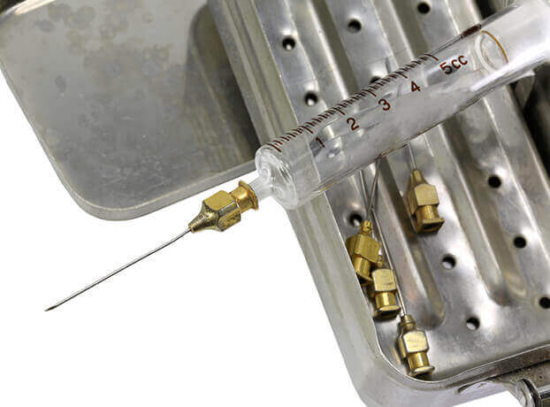 A close-up of an old-fashioned syringe loaded with insulin