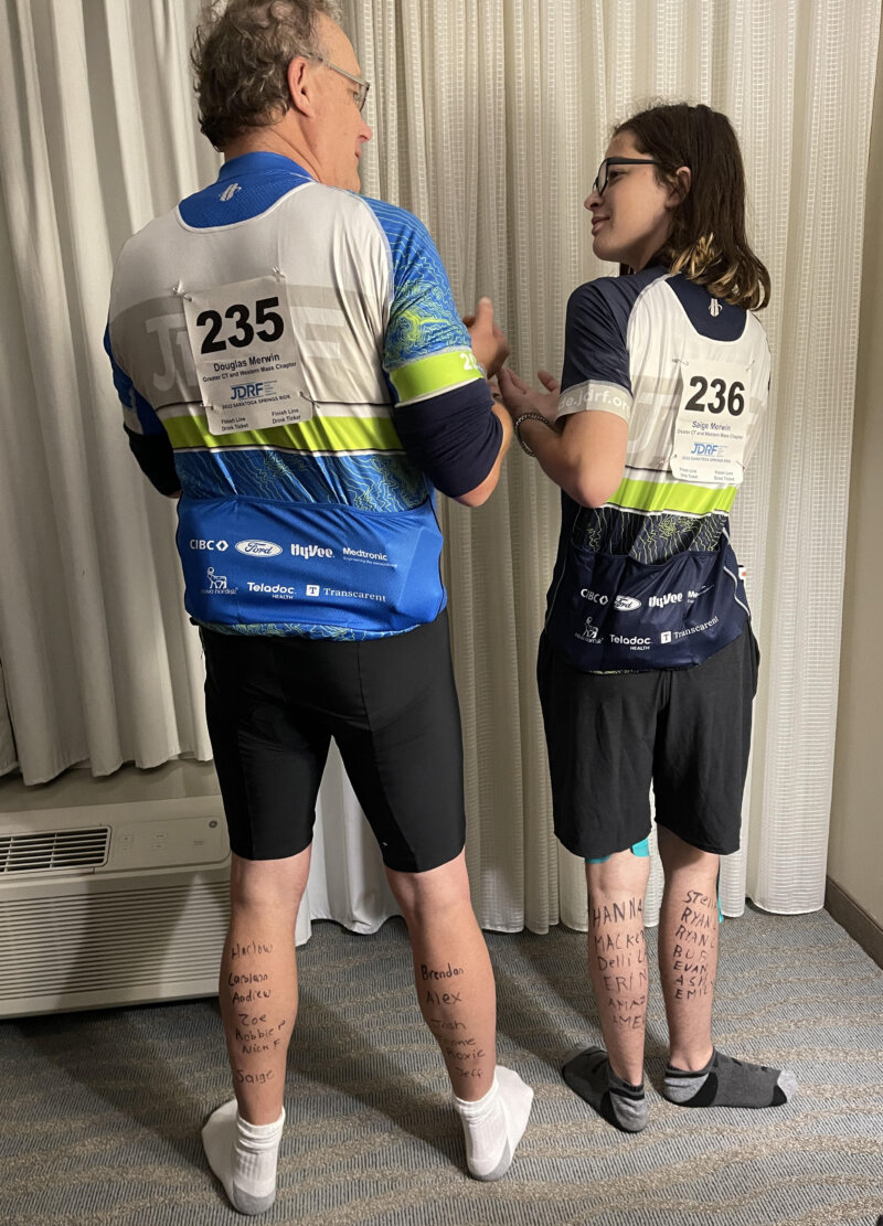 Doug and Saige with donor names written on their legs for inspiration